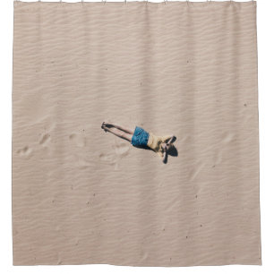 Aerial photograph of man lying on sand