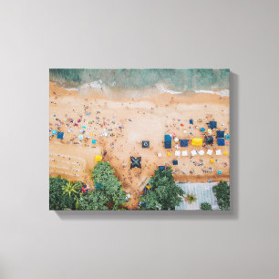 aerial view of beach filled with people and stalls canvas print