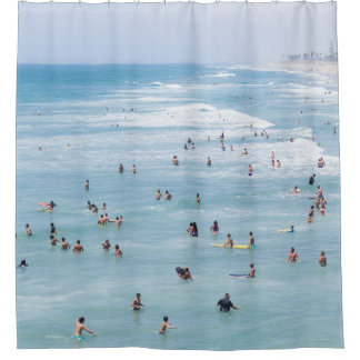 AERIAL VIEW OF GROUP OF PEOPLE SWIMMING ON BEACH