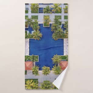 Aerial view of pool surrounded by palm trees bath towel