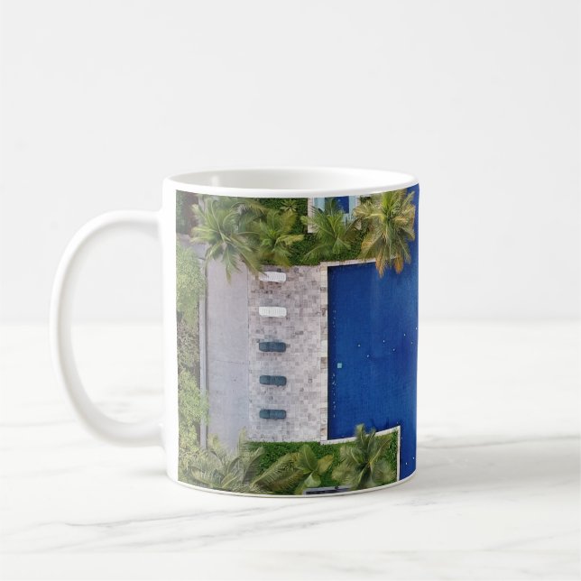 Aerial view of pool surrounded by palm trees coffee mug (Left)