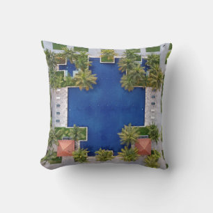 Aerial view of pool surrounded by palm trees throw pillow