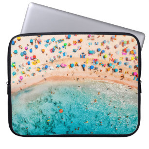 Aerial view of sandy beach with colourful umbrella laptop sleeve