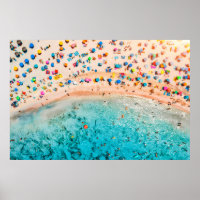 Aerial view of sandy beach with colourful umbrella