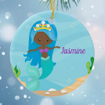African American Mermaid Girl Cute Custom Kids Ceramic Ornament<br><div class="desc">Cute custom mermaid Christmas ornament gift that features an adorable blue haired African American girl with a cool teal tail swimming next to beautiful seashells in the ocean. Cool present for a black beach girl who loves to swim.</div>
