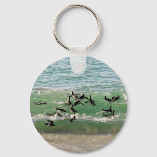 African penguins swimming at beach keychain