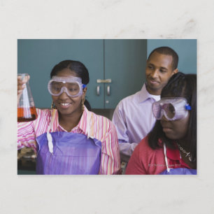 African teenage girl examining experiment in postcard