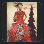 Afrocentric Dress Form Mannequin Christmas Tree Square Sticker<br><div class="desc">This Afrocentric Christmas Sticker features a photo image of a contemporary holiday tree made from a dress form dark-skin mannequin. The bodice is a short-sleeved sequined red dress and the bottom is made from artificial greenery decorated with red streamers and ornaments of purple, red and gold. The dress form has...</div>