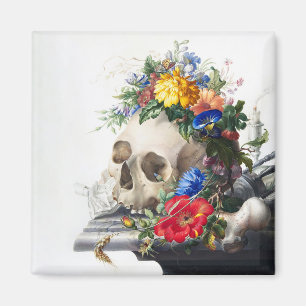 Aimant avec crâne et scène de fleurs.