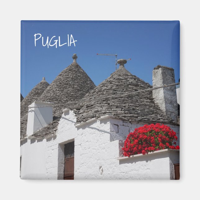 Aimant Fleurs de géranium et maisons de trulli à Alberobe (Devant)