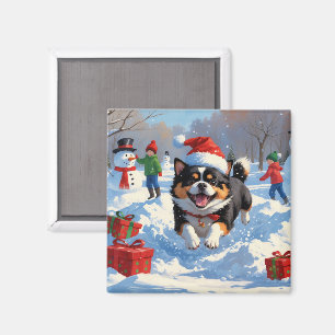 Aimant Japanese Chin courant dans la neige avec un chapea