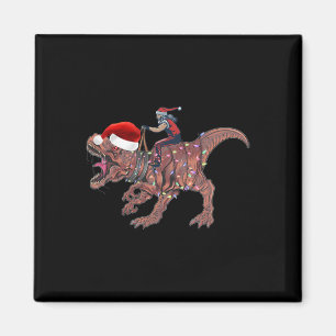 Aimant Père Noël à cheval sur un dinosaure T Rex Noël Gar