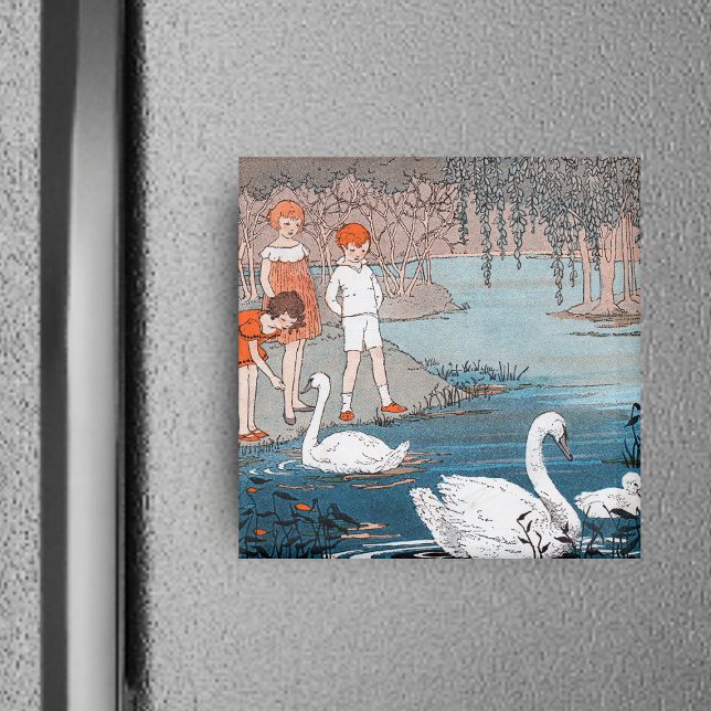 Aimant pour enfants et cygnes (Children red hair at shore of blue lake feeding pretty white swans on square magnet.)