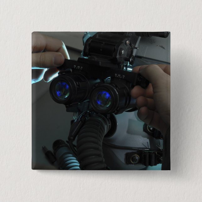 Airman adjusts the eyespan 2 inch square button (Front)