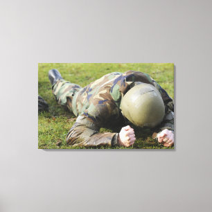 Airman crawls through a wet field canvas print