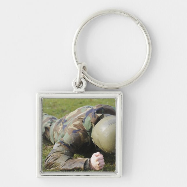 Airman crawls through a wet field keychain (Front)