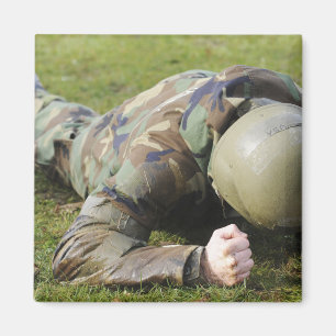 Airman crawls through a wet field magnet