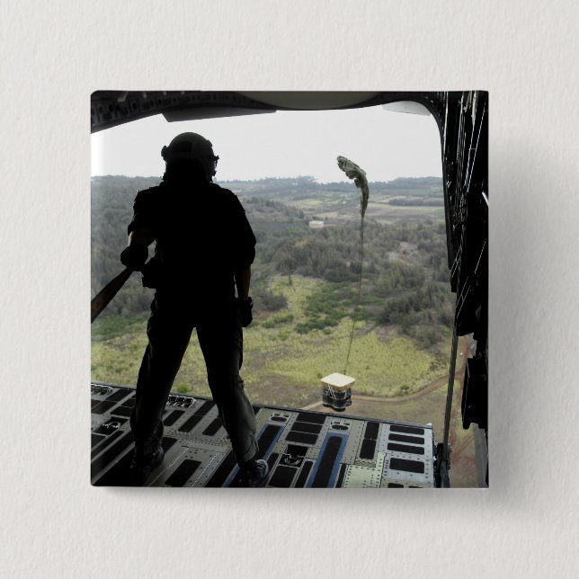 Airman watches a practice bundle fall 2 inch square button (Front)