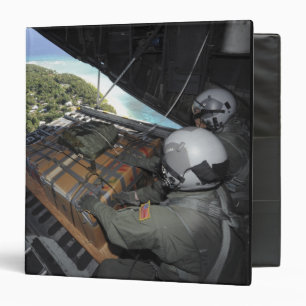 Airmen push out a pallet of donated goods 2 binder