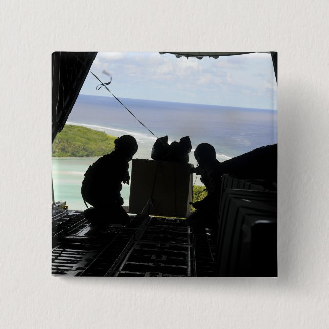 Airmen push out a pallet of donated goods 2 inch square button (Front)