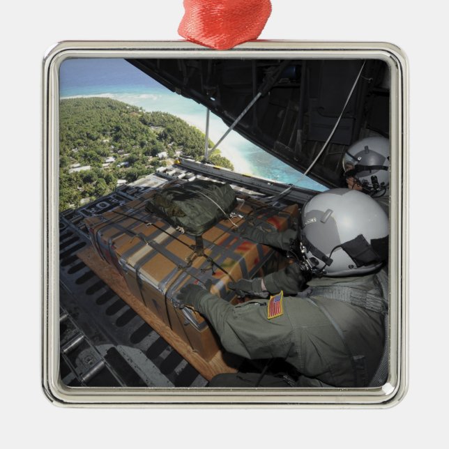 Airmen push out a pallet of donated goods 2 metal ornament (Front)