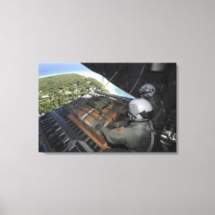 Airmen push out a pallet of donated goods canvas print