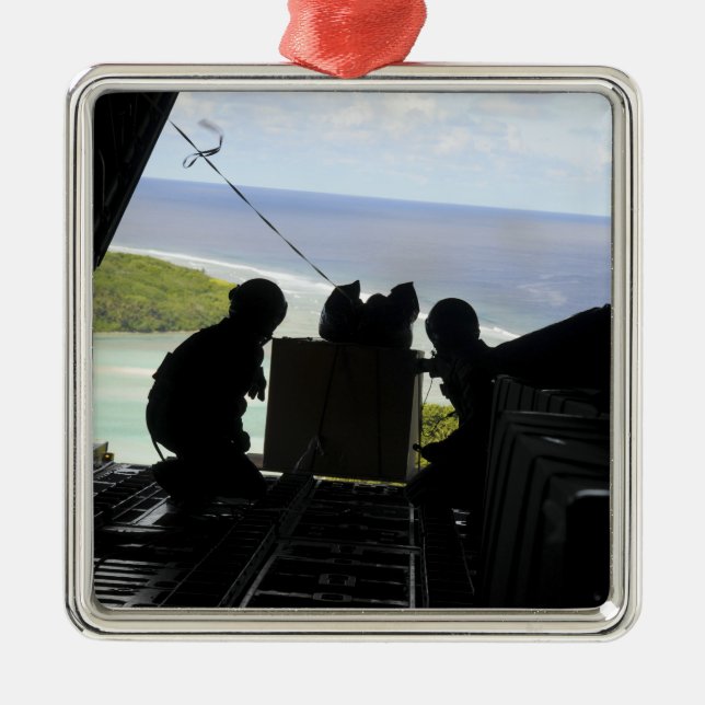 Airmen push out a pallet of donated goods metal ornament (Front)