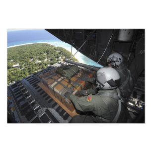 Airmen push out a pallet of donated goods photo print