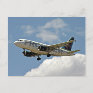 Airplane coming out of clouds and roar through sky postcard