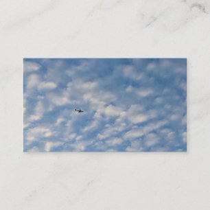 Airplane Crossing a Cloud-Filled Blue Sky Business Card