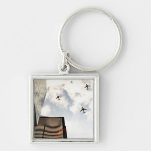 Airplanes flying over buildings keychain