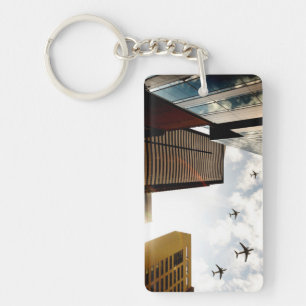 Airplanes flying over buildings keychain
