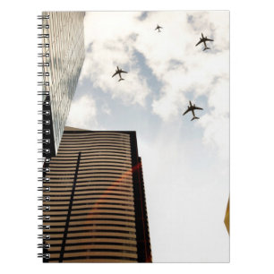 Airplanes flying over buildings notebook