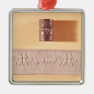 Akkadian cylinder seal and impression metal ornament