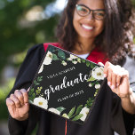 Alabaster Floral | Custom School Name & Class Year Graduation Cap Topper<br><div class="desc">Beautiful grad cap topper features "graduate" in elegant white calligraphy script,  on a black background adorned with white watercolor flowers and green foliage. Personalize with your class year and/or school.</div>