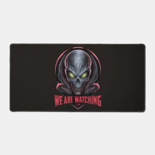 Alien with Glowing Green Eyes We are Watching Desk Mat
