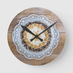 Almond nut cake on rustic wood round clock