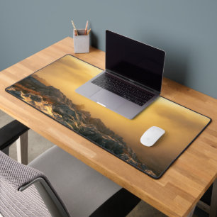 Amazing sunset above clouds and sun lit rocks desk mat