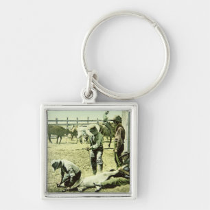 American cowboys branding a calf, c.1900 (photo) keychain