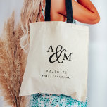 Ampersand Monogram Wedding Welcome Tote Bag<br><div class="desc">Simple and chic wedding welcome tote bags feature your initials worked into a monogram design,  joined by a decorative script ampersand. Personalize with your wedding date and location beneath in timeless serif lettering. Perfect as favours or hotel gift bags.</div>