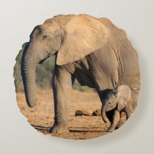 An African Elephant mother and calf on the move Round Pillow