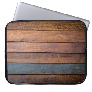 An antique wood wall texture background with metal laptop sleeve
