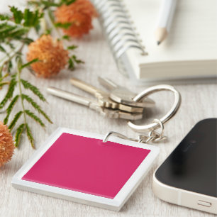 An array of red and pink flowers with lush green l keychain