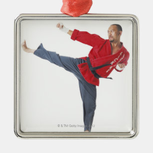 an asian male karate black belt wearing a red metal ornament
