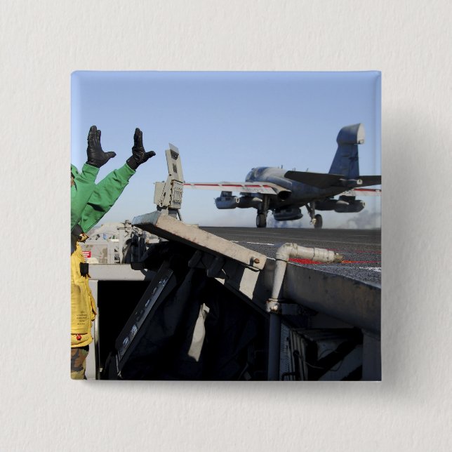 An EA-6B Prowler launches from the flight deck 2 Inch Square Button (Front)