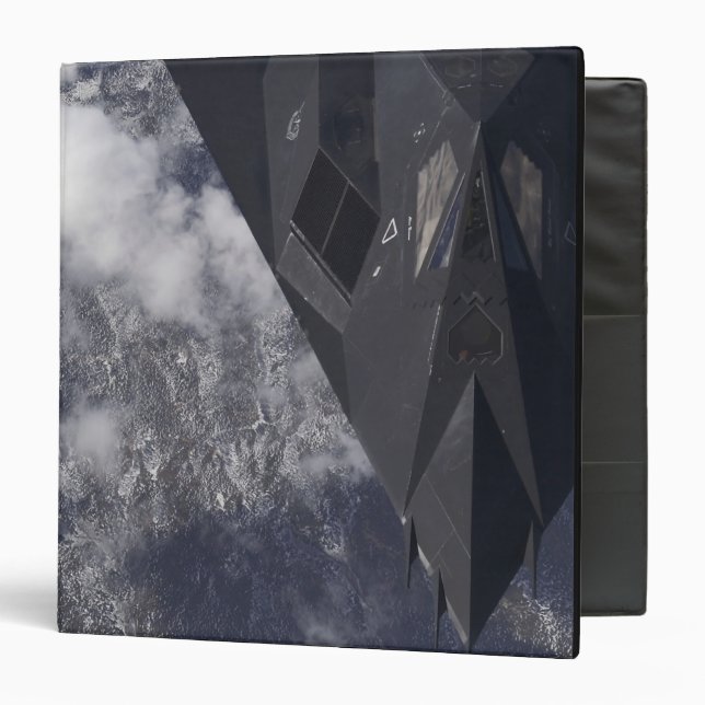An F-117A Nighthawk flies high over the mountai Binder (Front/Inside)
