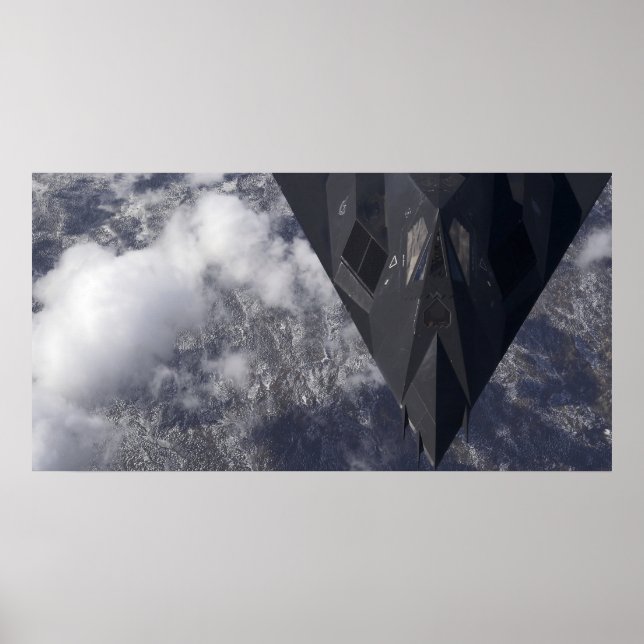 An F-117A Nighthawk flies high over the mountai Poster (Front)