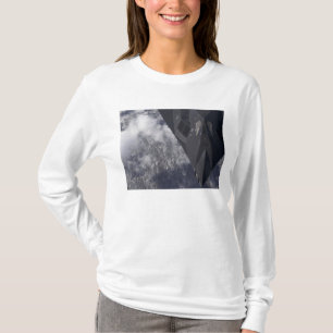 An F-117A Nighthawk flies high over the mountai T-Shirt