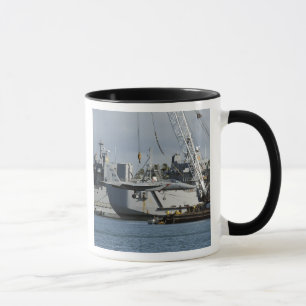 An F-15 Eagle gets a lift from a barge crane Mug