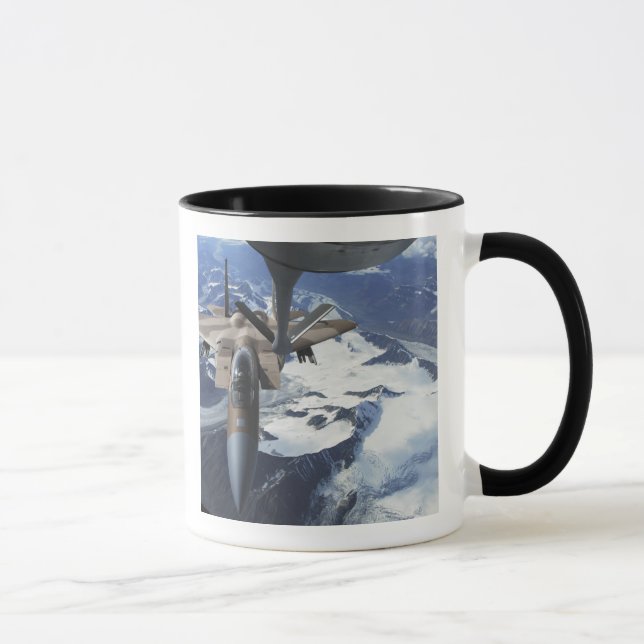 An F-15C Eagle aircraft sits behind a KC-135R Mug (Right)